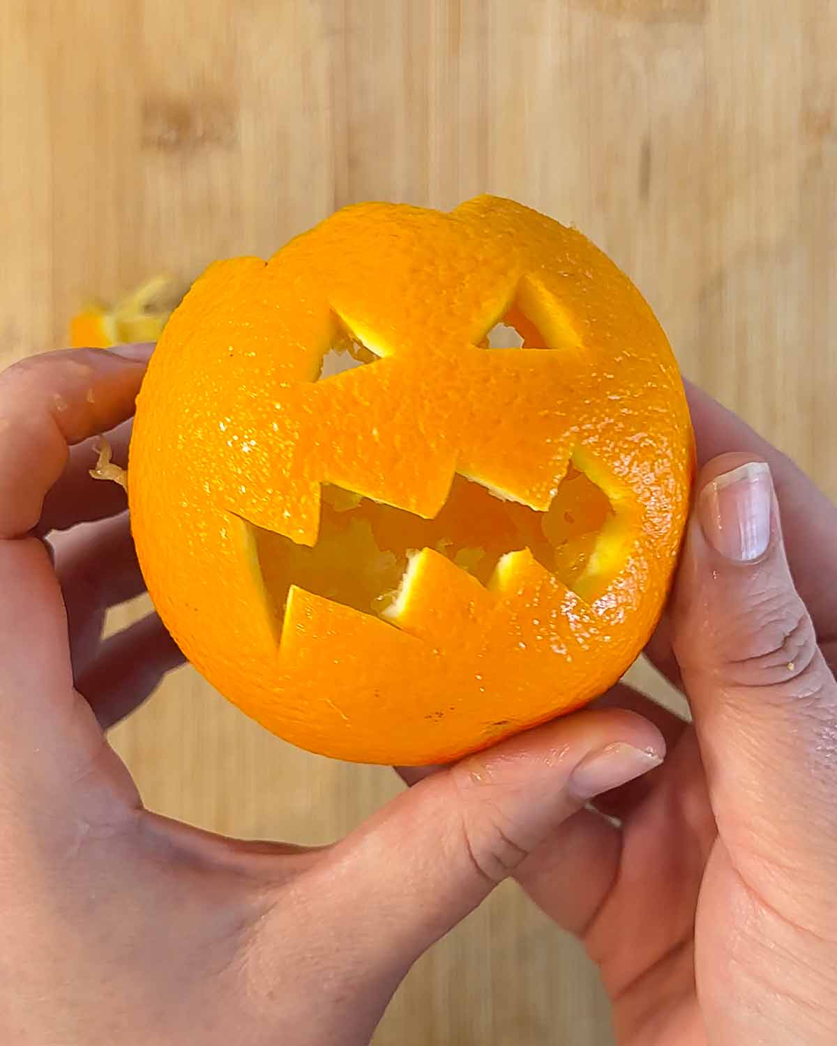 An orange skin witha  Jack O'Lantern face cut into it.