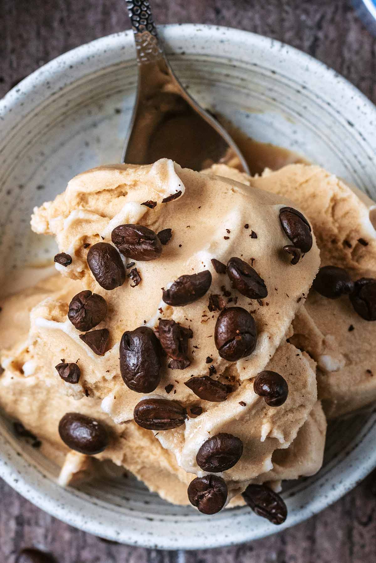 Coffee ice cream with roasted coffee beans on top of it.