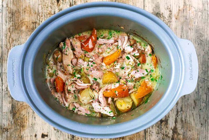 A slow cooker bowl full of chicken casserole.