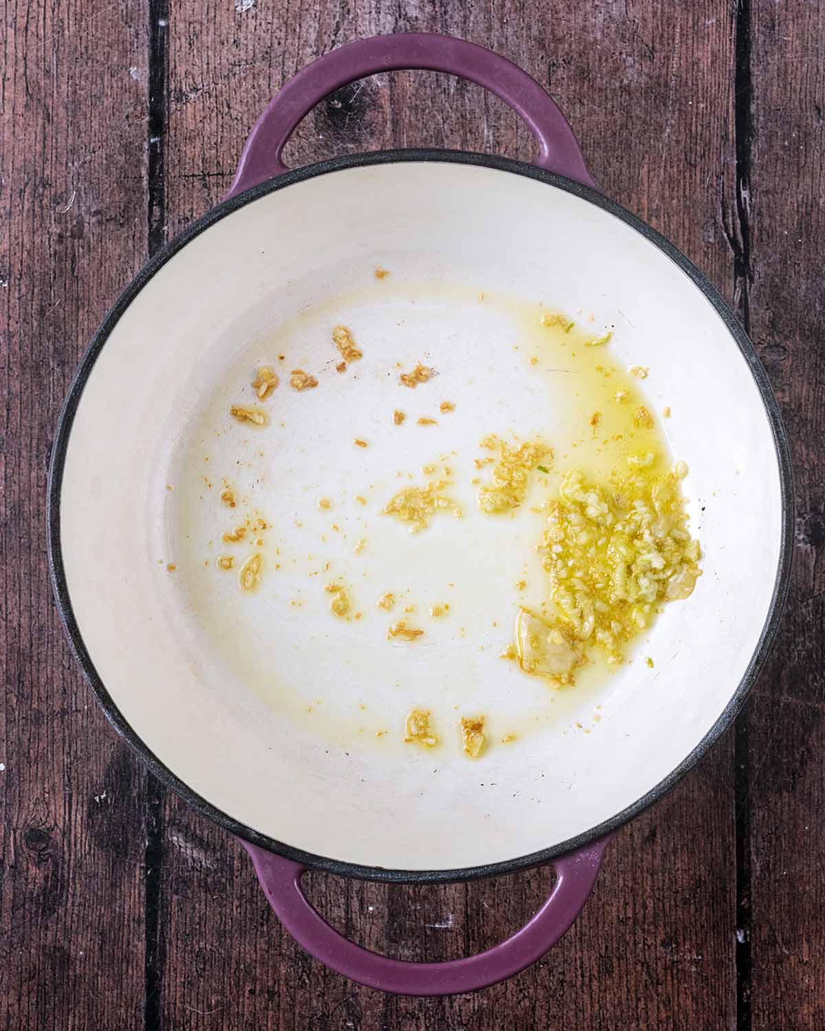 Crushed garlic cooking in a large pan.