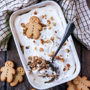 A baking dish full og gingerbread baked oats with a spoon removing a portion.