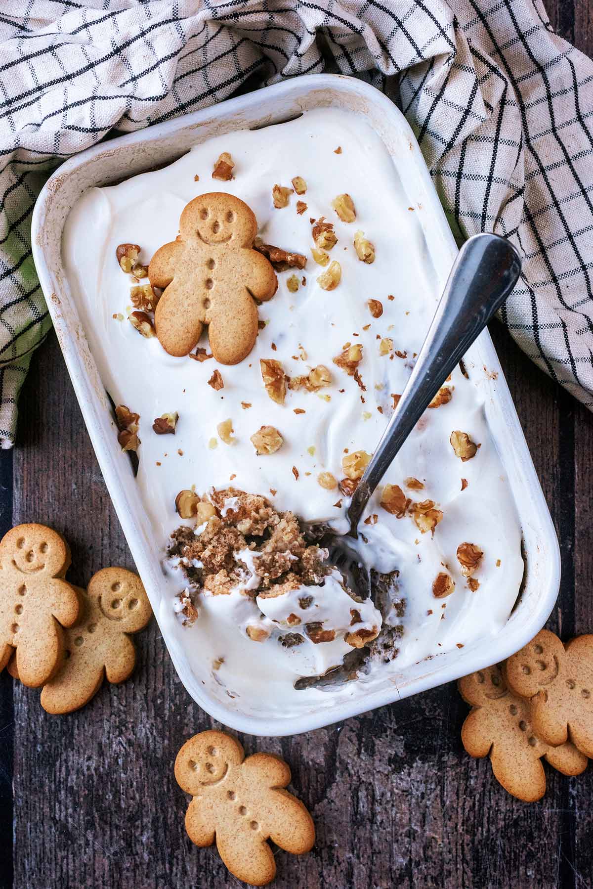 A baking dish full of yogurt topped baked oats with a spoon in it.