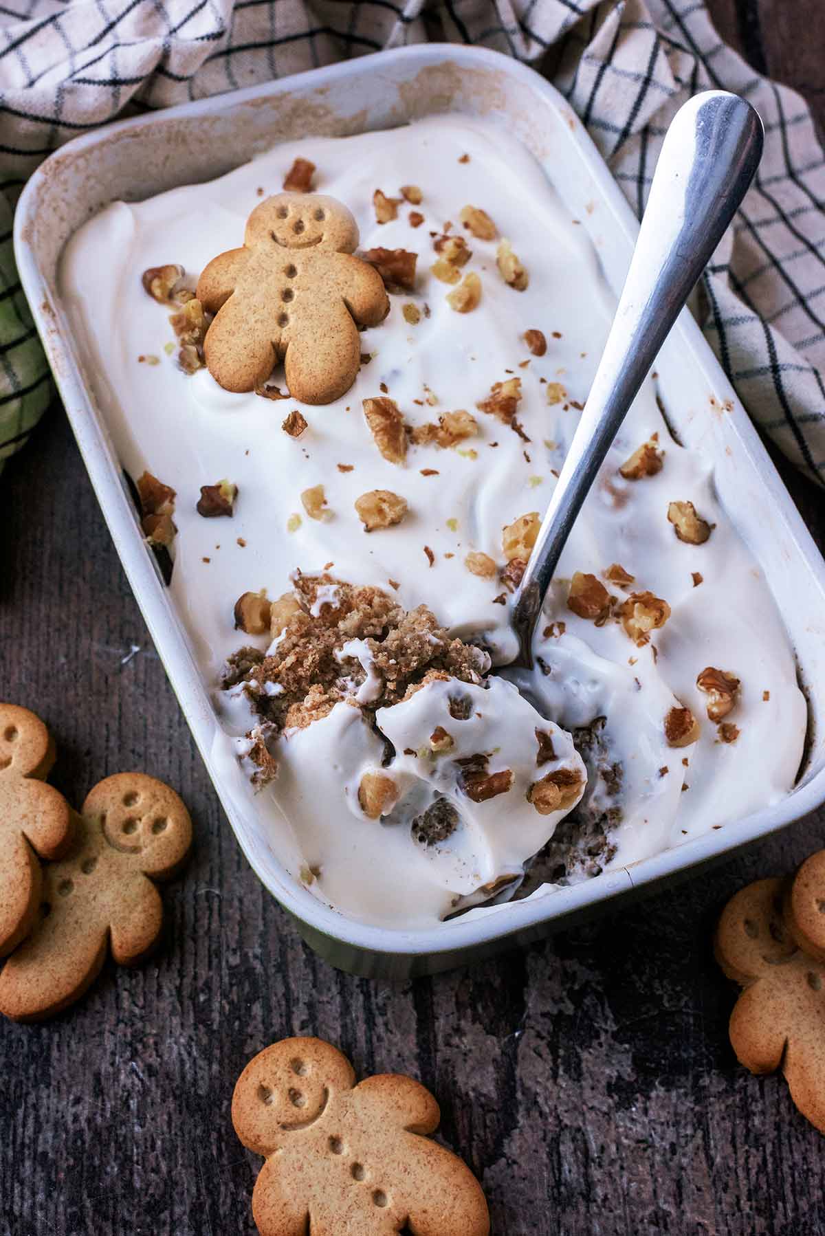 A baking dish of yogurt topped baked oats with a spoon.