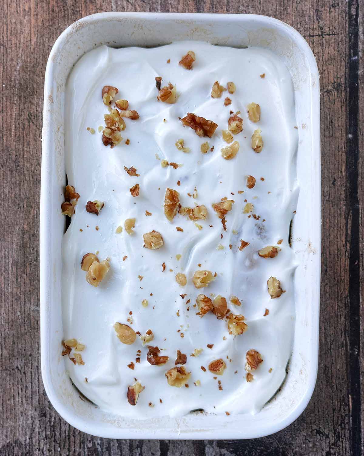 Yogurt spread over the baked oats then crushed walnuts sprinkled on top.