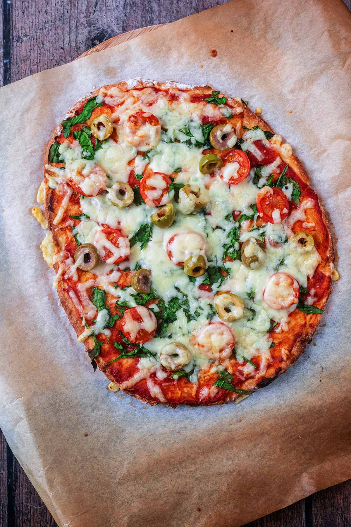 a vegetable pizza on a sheet of baking powder.