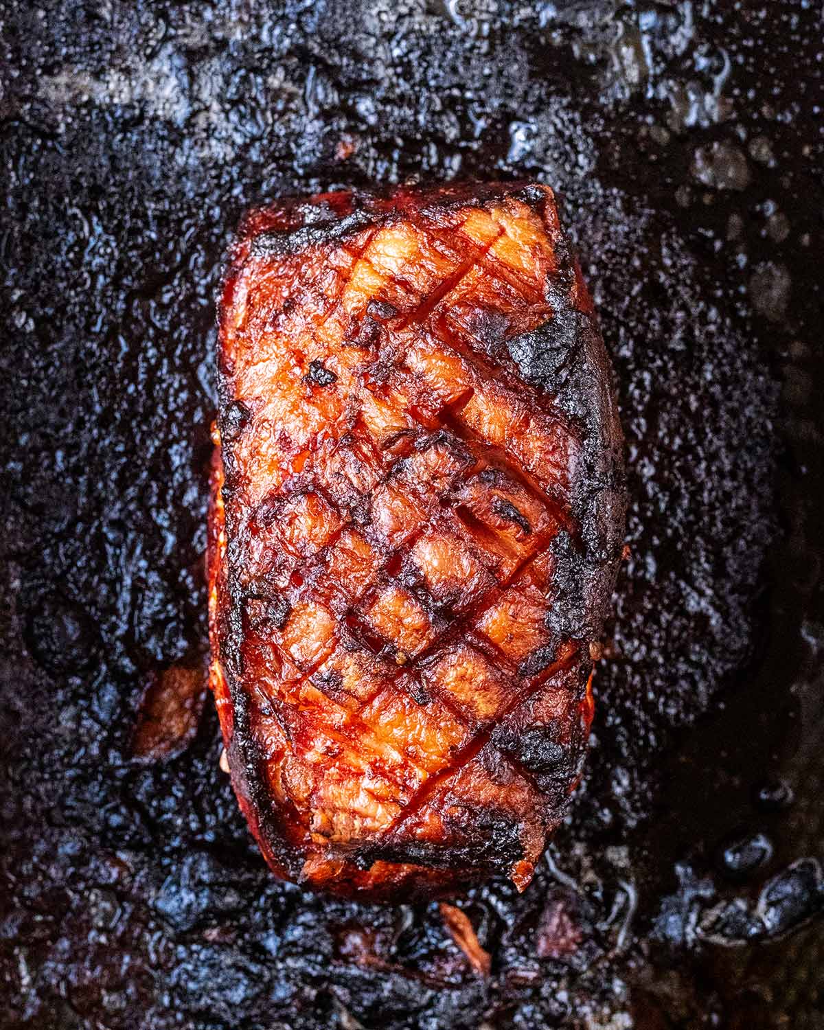 Cooked honey glazed ham in the baking tray.