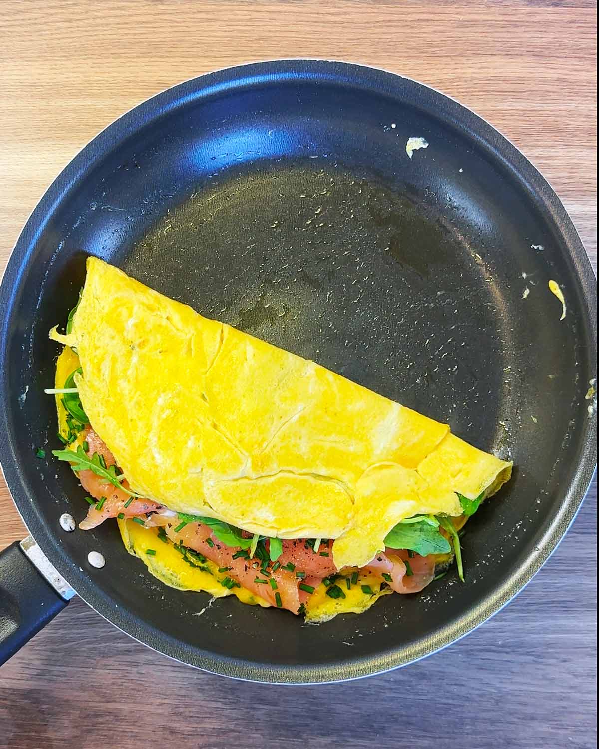 A folded omelette in a frying pan.