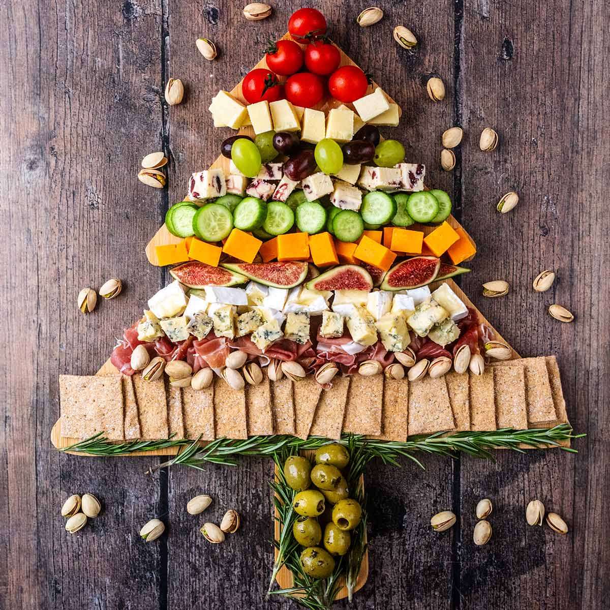 A Christmas Tree Cheese Board on a wooden surface.