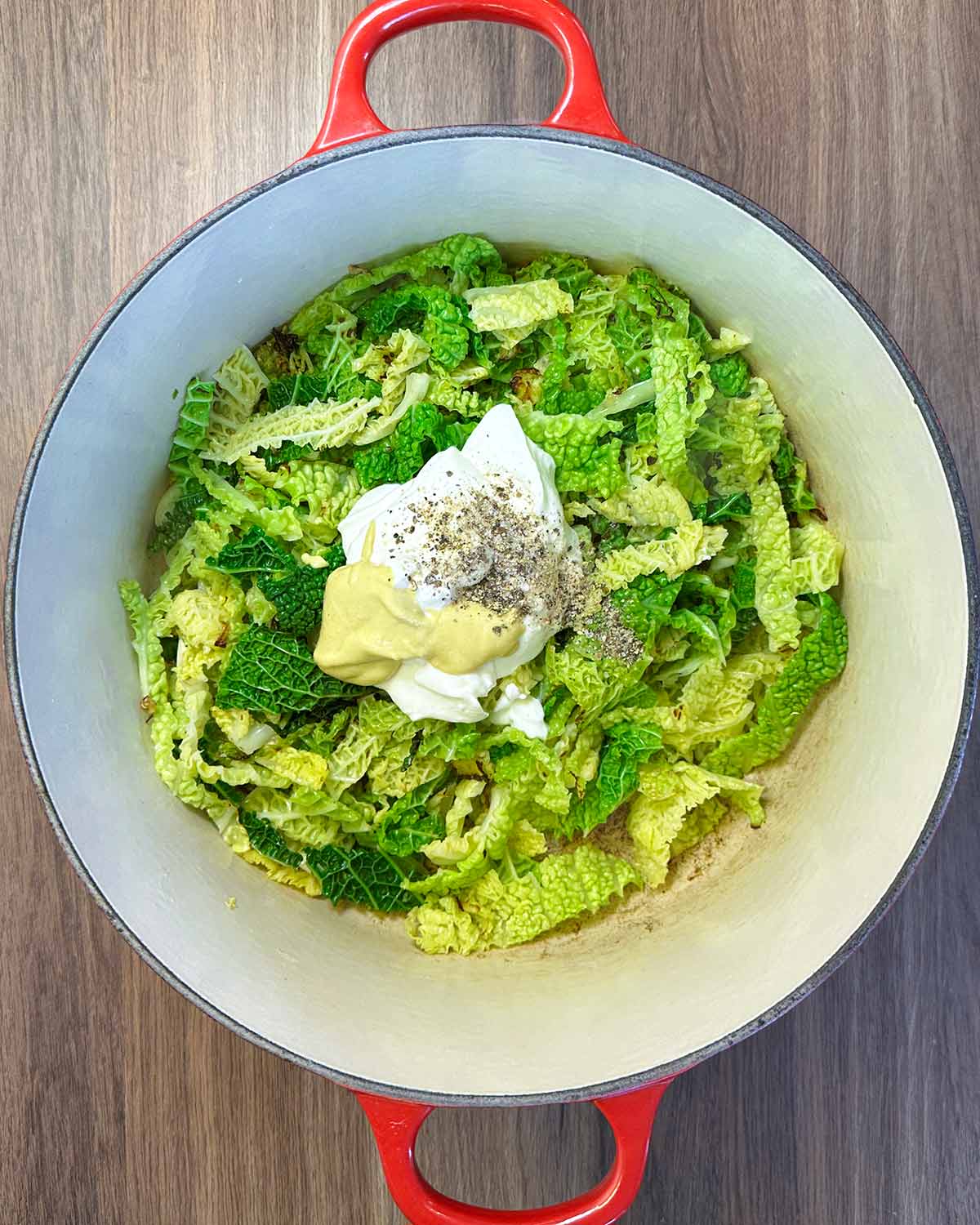 Cream, mustard, salt and pepper added to the cabbage.