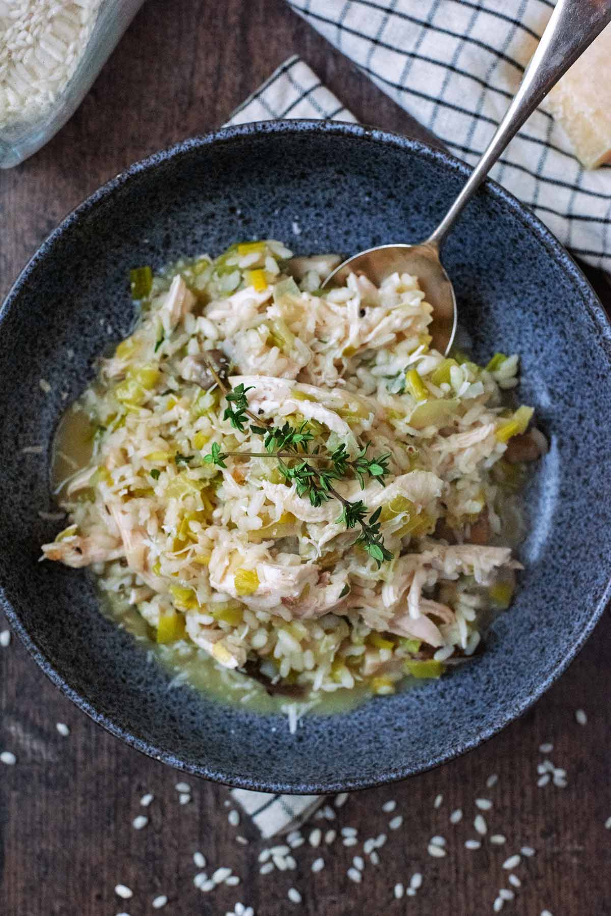 A bowl of risotto with a spoon in it.