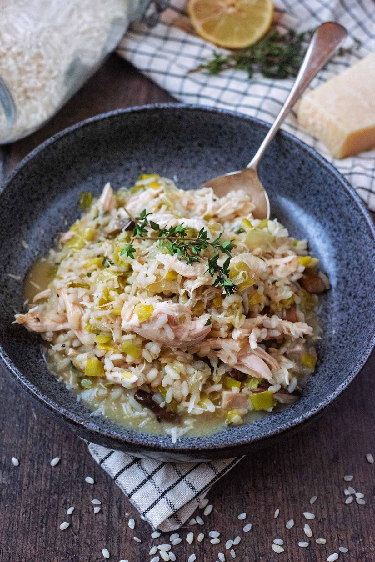 A spoon in a portion of turkey risotto.