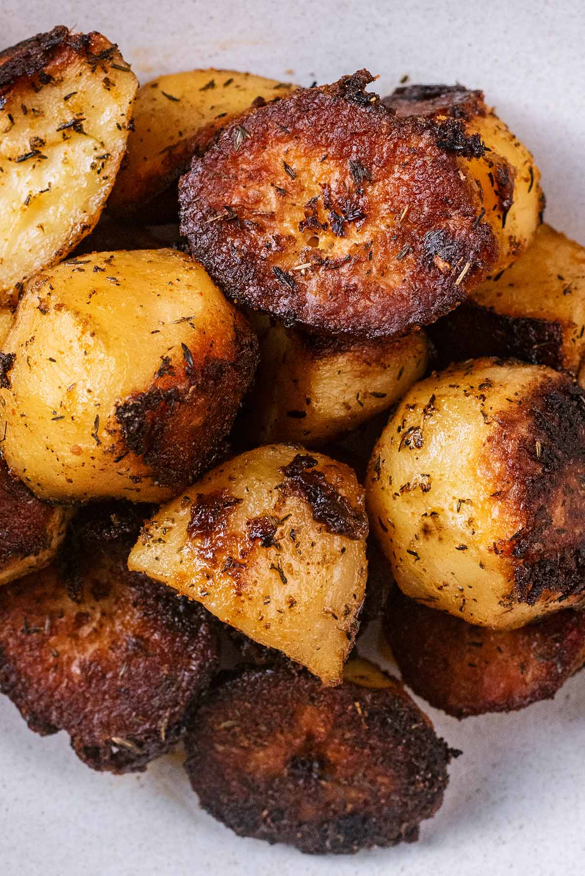 Crispy roast potatoes on a grey plate.