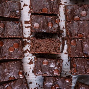 Cottage cheese brownies cut into bars on a sheet of parchment paper.