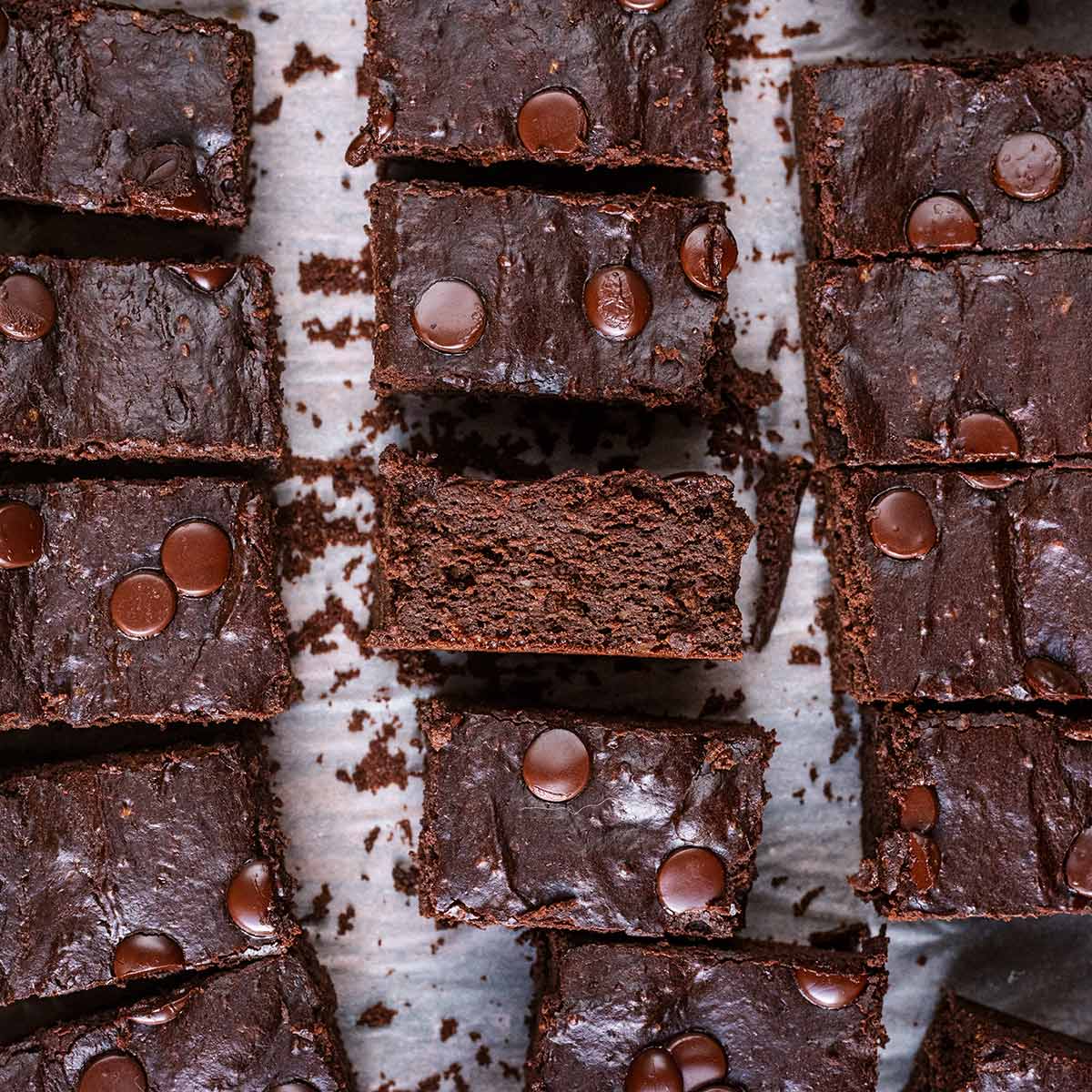 Cottage cheese brownies cut into bars on a sheet of parchment paper.
