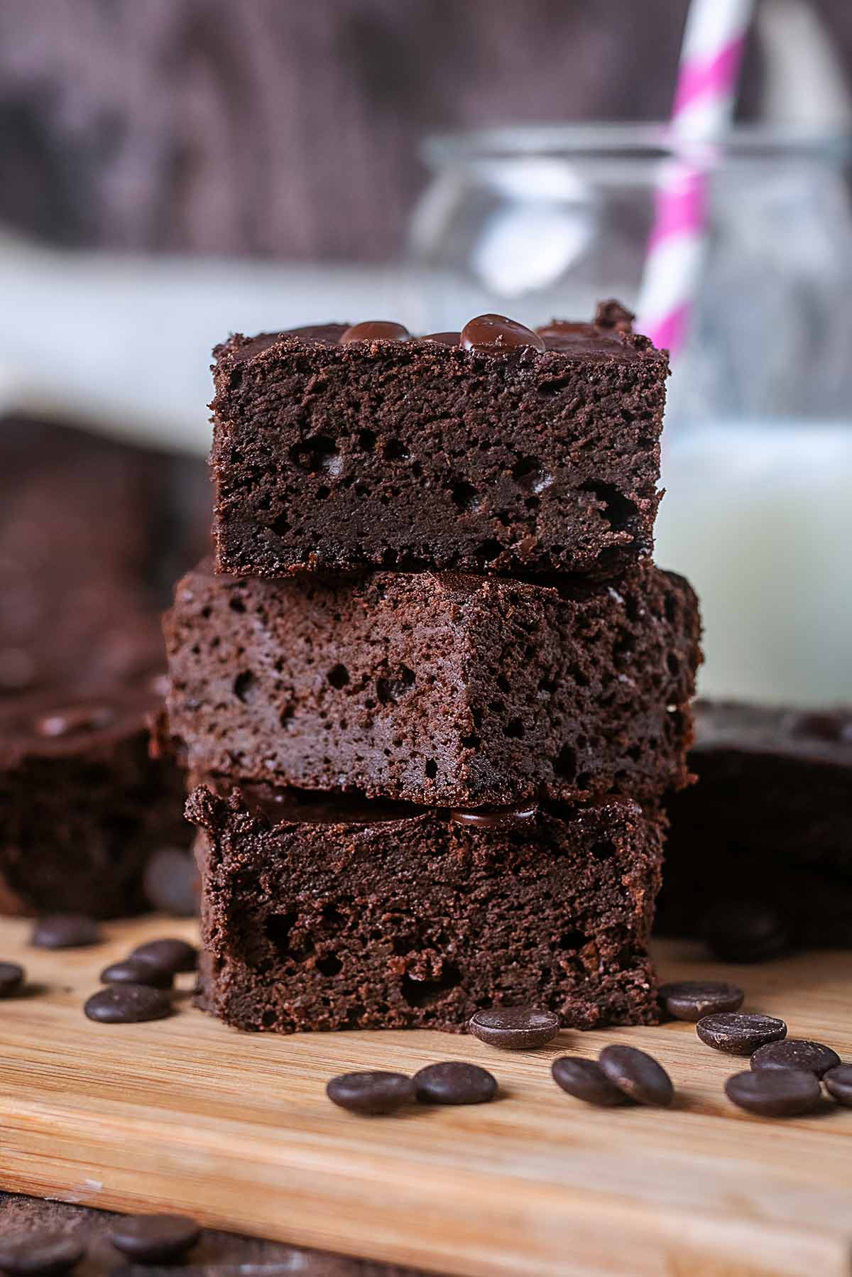 A stack of three fudgy chocolate brownies.