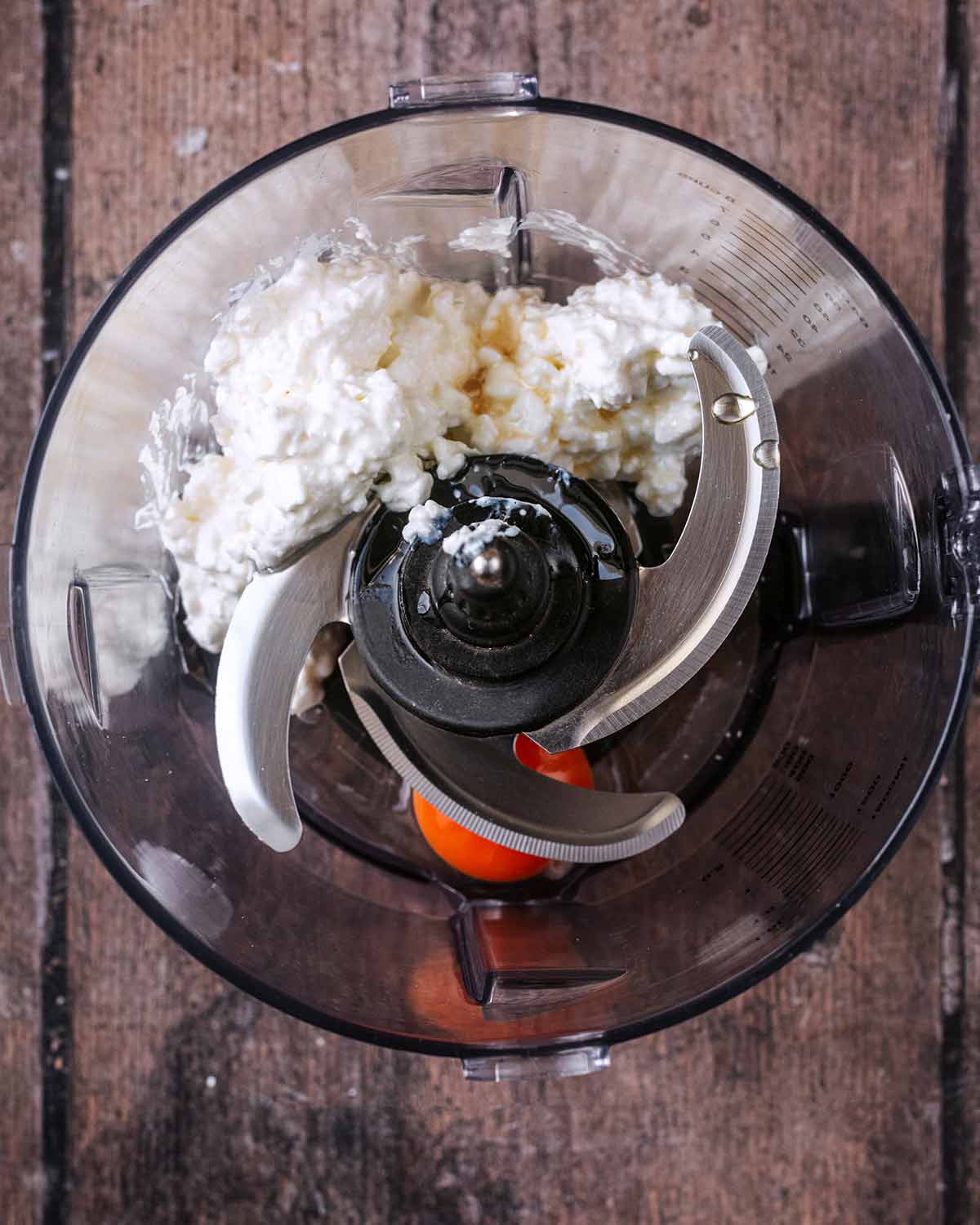 A food processor containing cottage cheese, egg and vanilla.