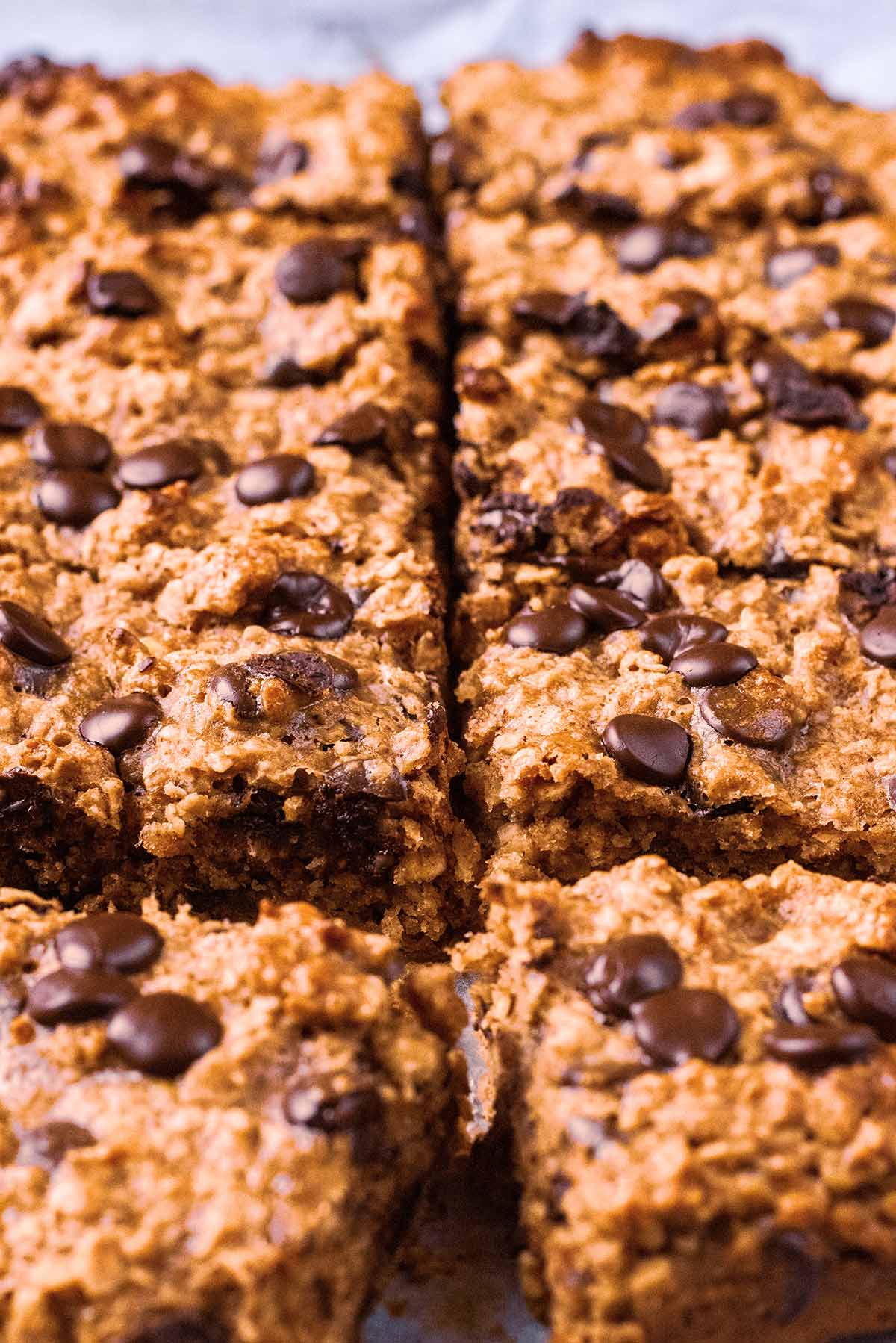 A slab of breakfast cake cut into ten individual bars.