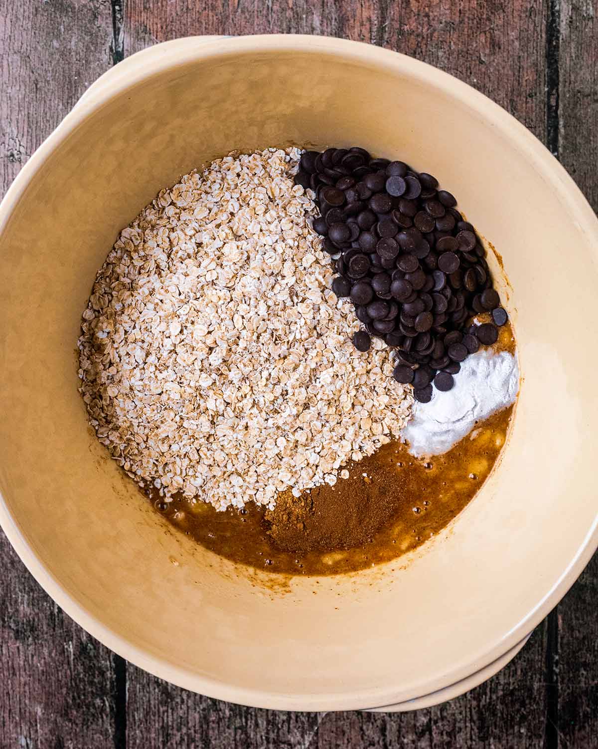 Oats and chocolate chips added to the bowl.