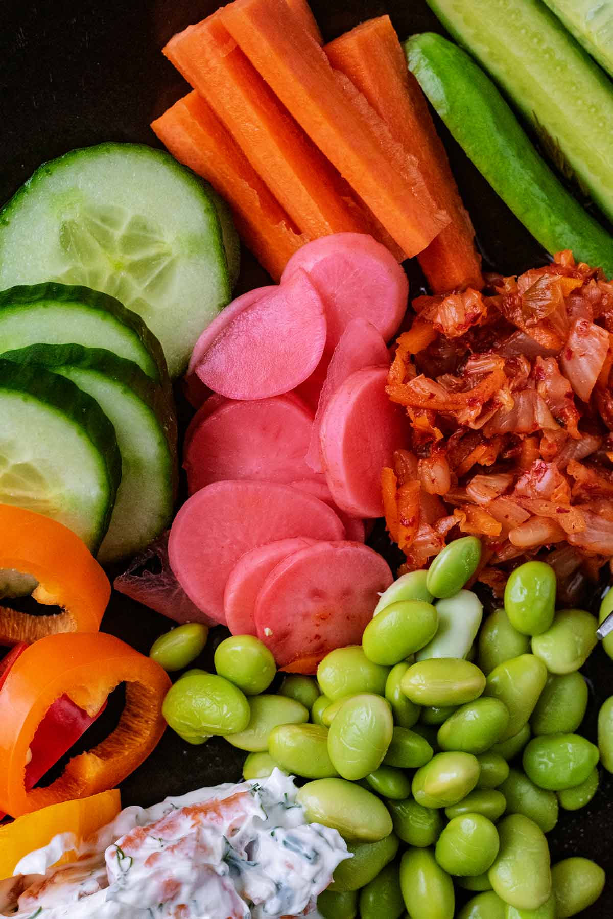 Pickled radishes on a plate, surrounded by various salad items.