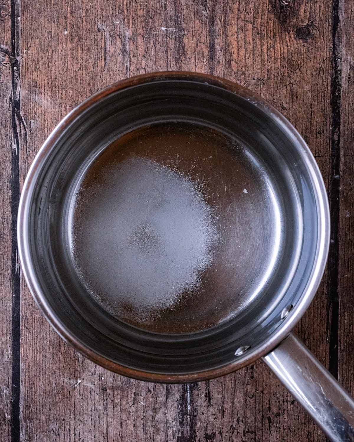 A saucepan with water, vinegar, sugar and salt.