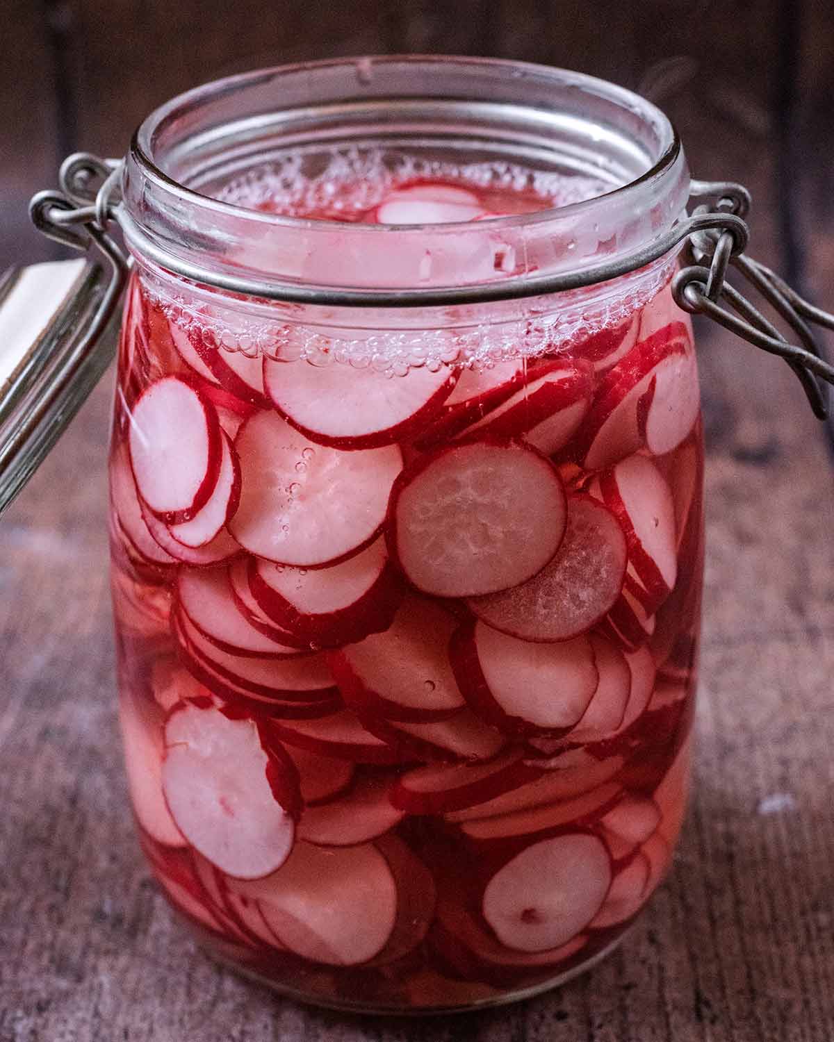 Pickling vinegar added to the radishes.