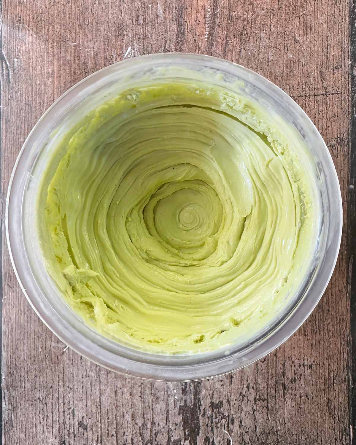 Churned pistachio ice cream in the Creami tub.