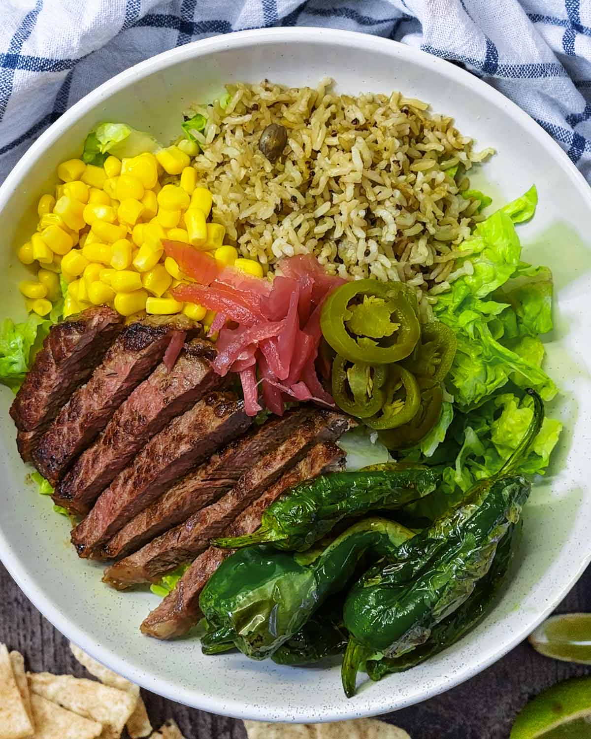 Steak, peppers and onions added to the bowl.