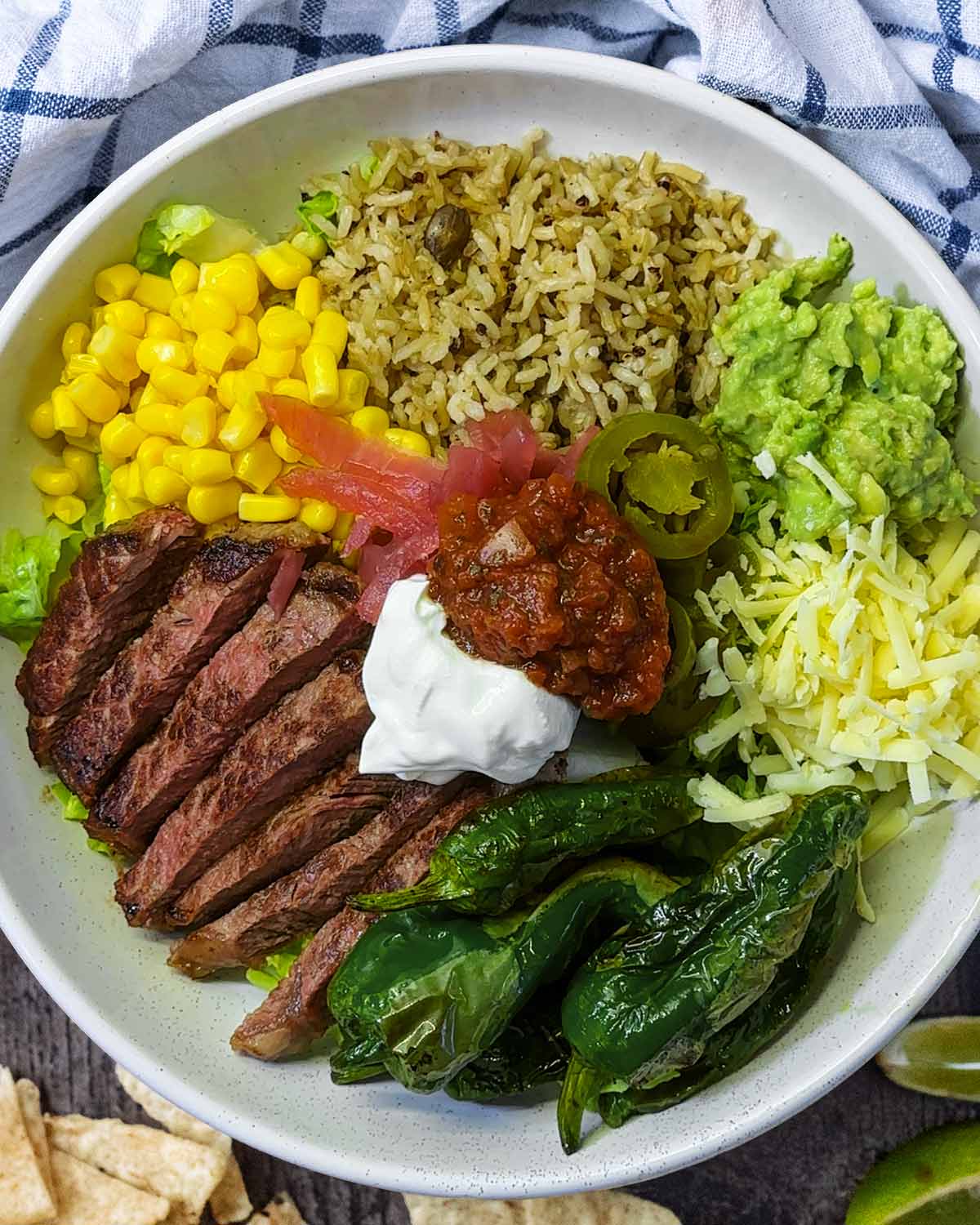 Guacamole, sour cream and salsa added to the bowl.