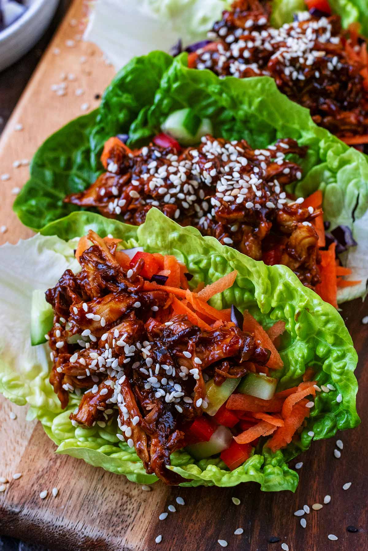 Teriyaki chicken and chopped vegetables in a lettuce leaf.