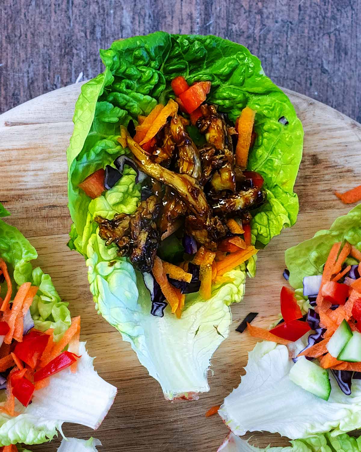 Cooked teriyaki chicken and sesame seeds added to the lettuce leaf.