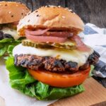 A turkey smash burger in a bun on a piece of parchment paper.