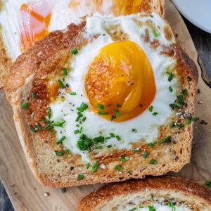 Air fryer egg toast on a wooden serving board.