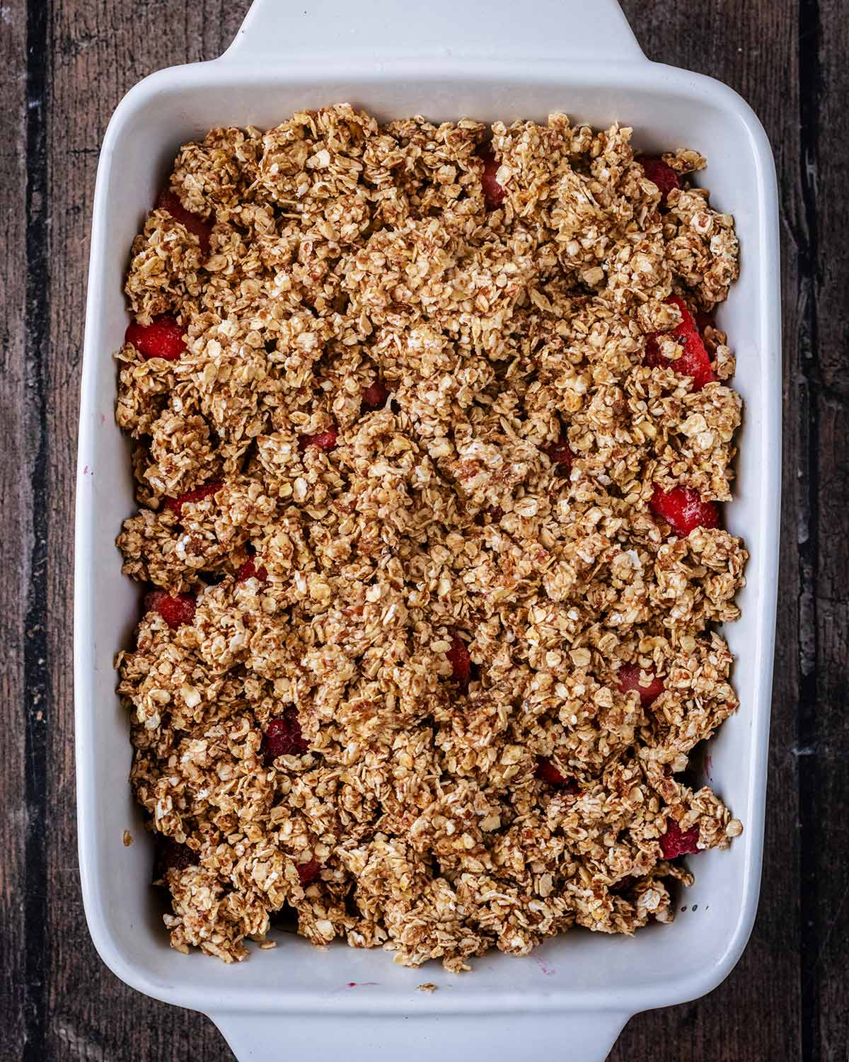 The crumble mixture spread over the berries.