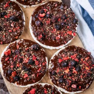 Homemade chocolate rice cakes on a wooden board.