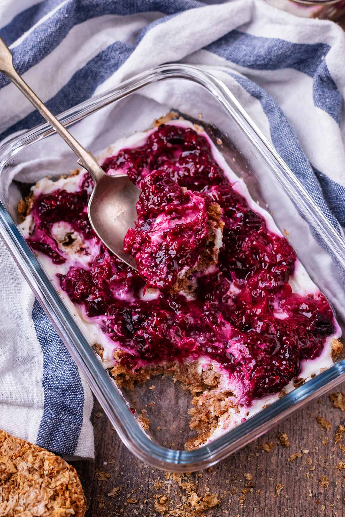 A rectangular glass bowl containing overnight Weetabix topped with yogurt and jam.