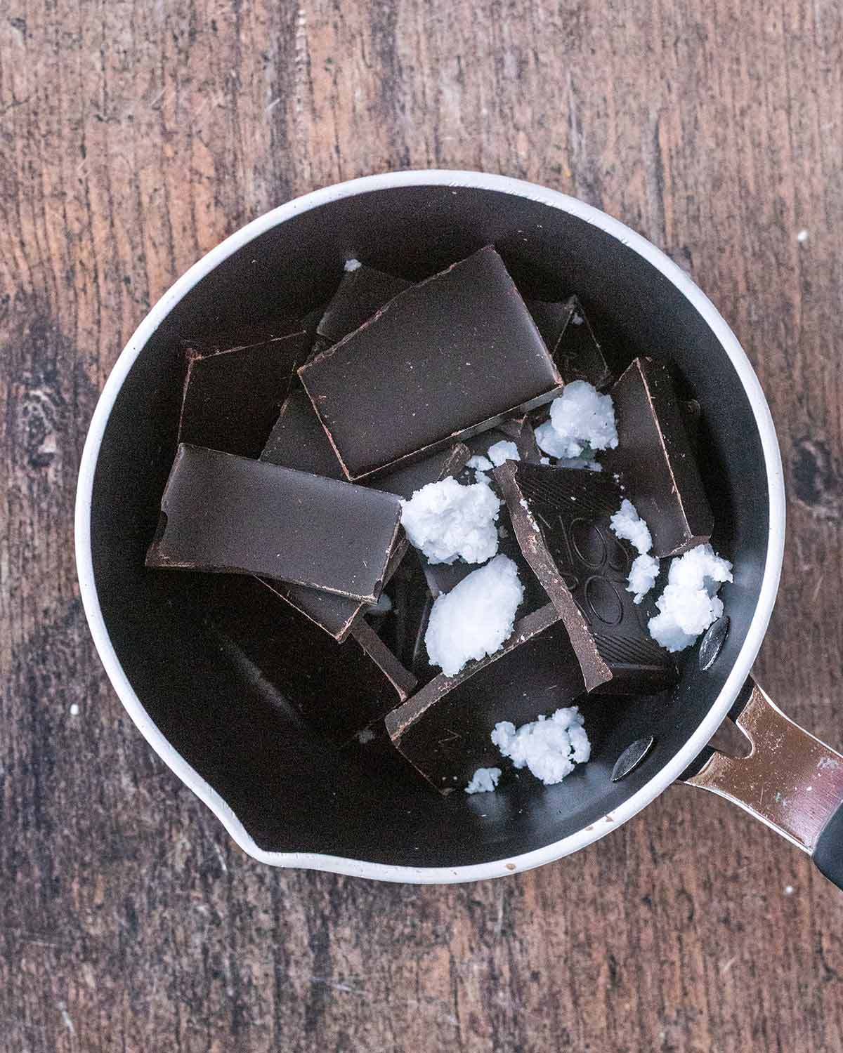 Dark chocolate and coconut oil in a small saucepan.