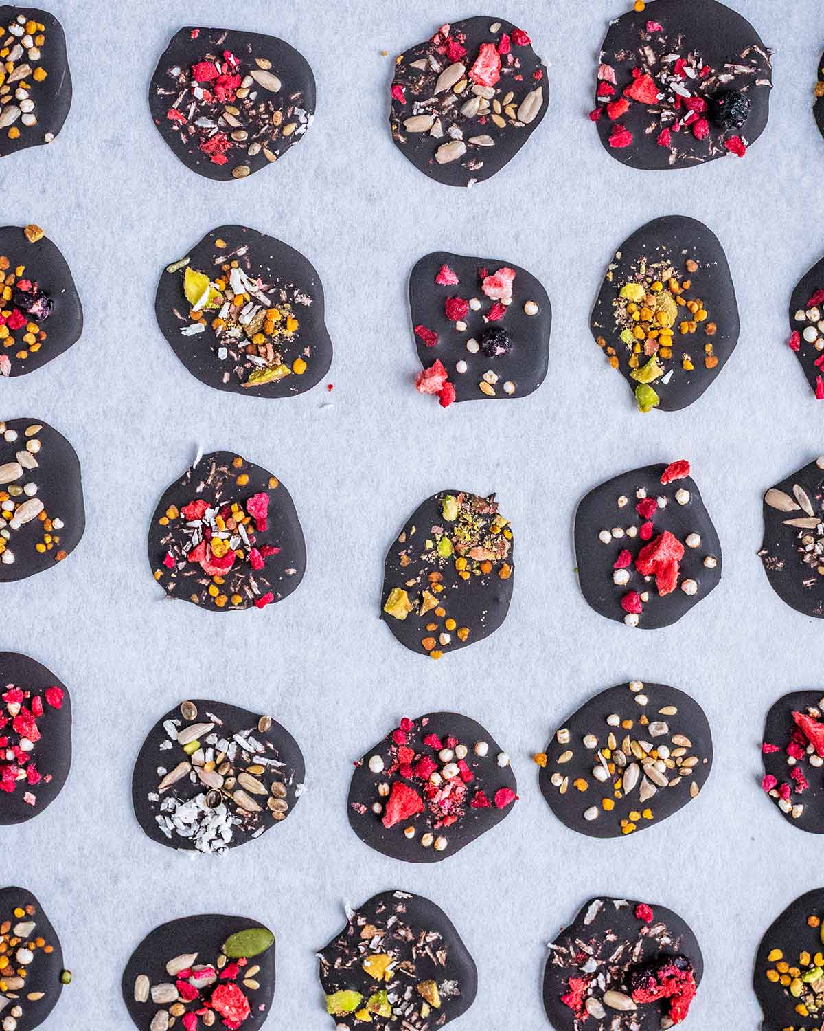 The chocolate now set into solid buttons with the toppings stuck on top.