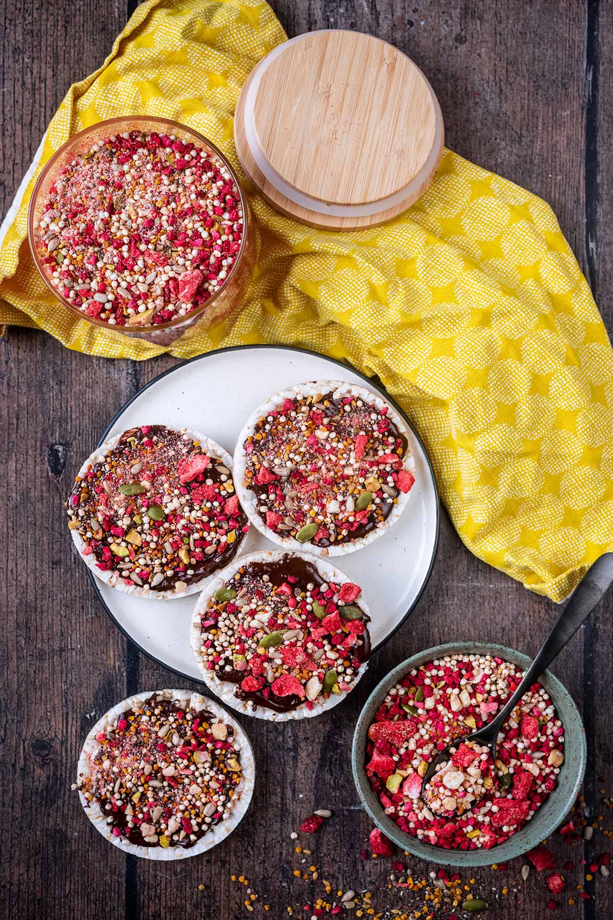 Four chocolate covered rice cakes topped with sprinkles.