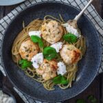 A bowl of chicken and ricotta meatballs and spaghetti.