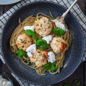 A bowl of chicken and ricotta meatballs and spaghetti.