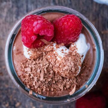 A glass pot full of chocolate protein pudding.