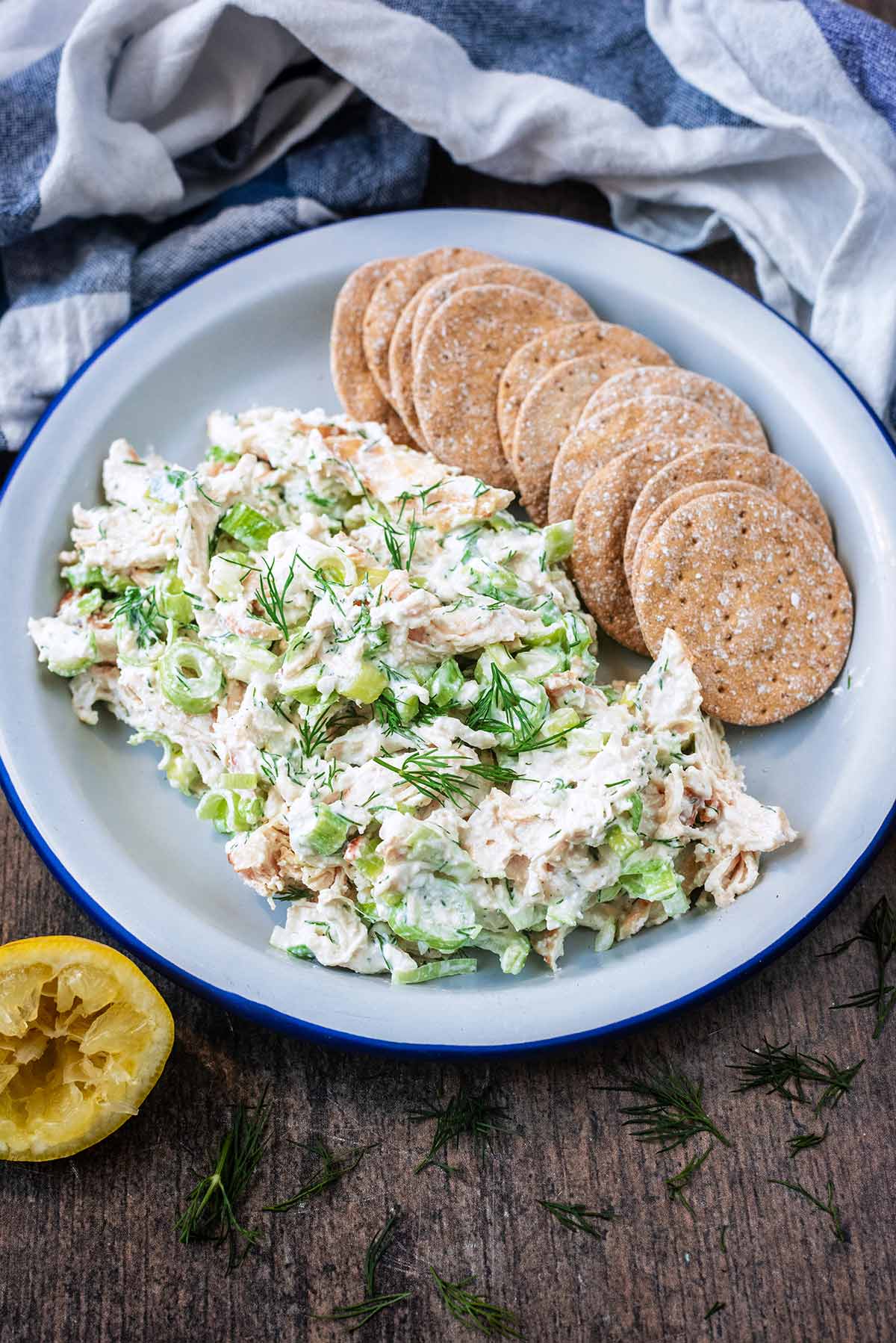 A plate of creamy chicken salad and some sourdough crackers.