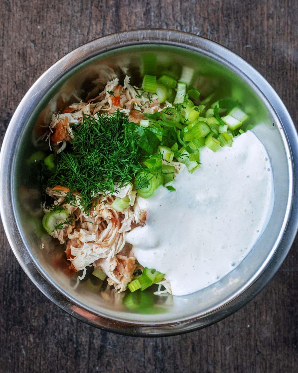 Blended cottage cheese poured into the bowl of chicken.