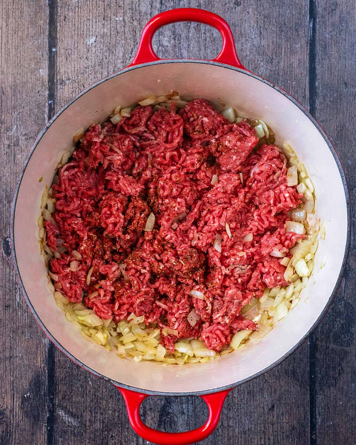 Ground beef added to the pan.