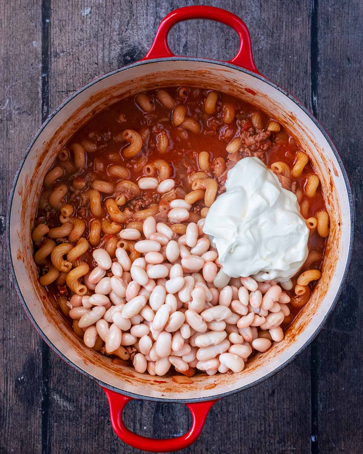 Beans and cream added to the pan.