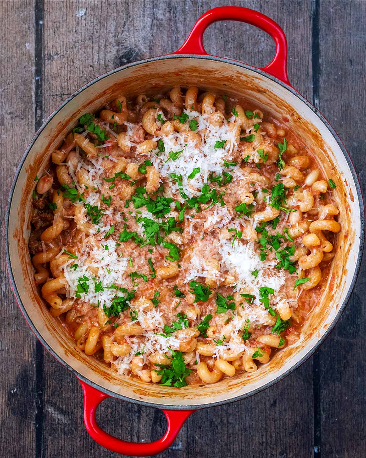 Grated parmesan and chopped herbs on top of the beef pasta.