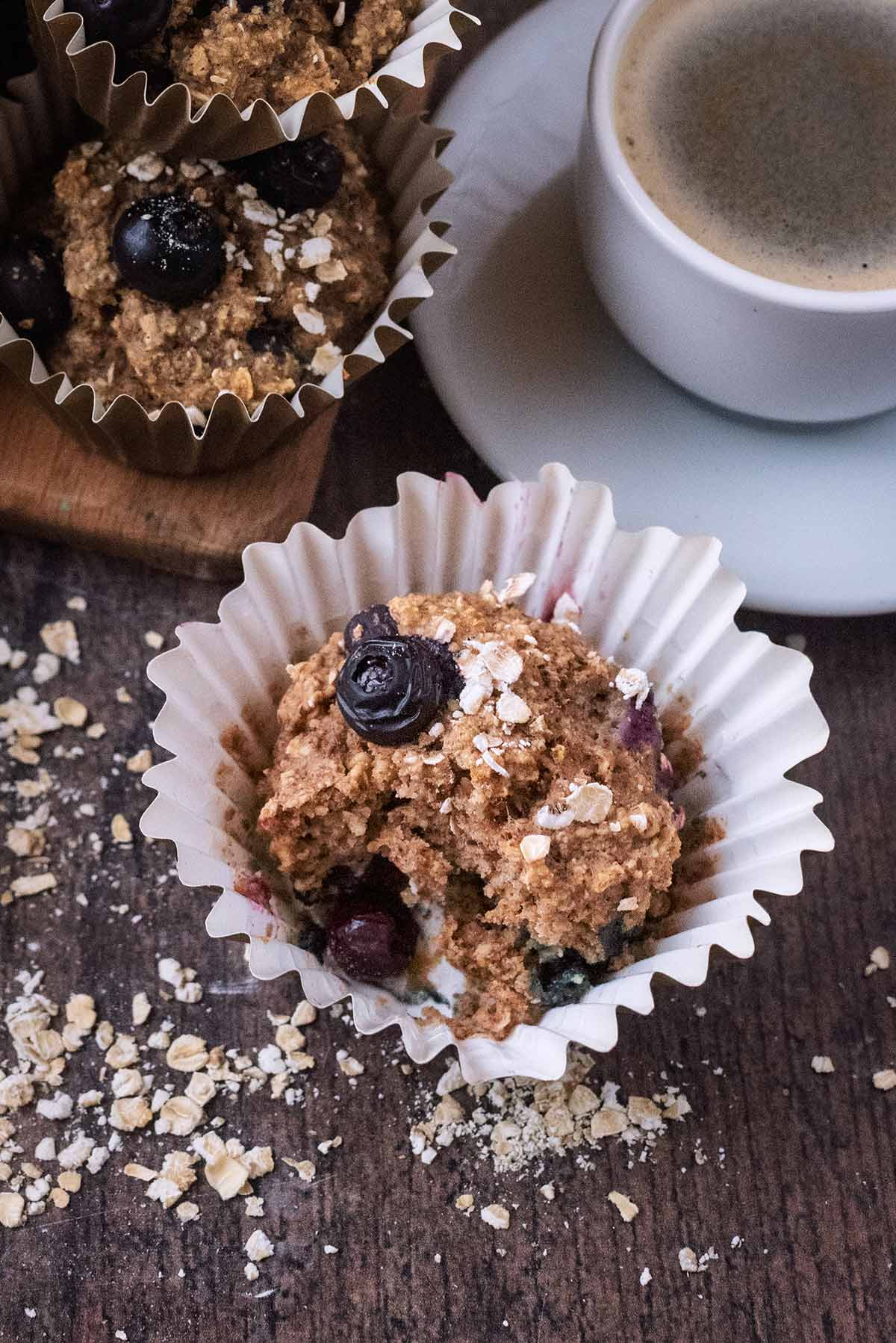 A blueberry muffin with a bite taken out of it.