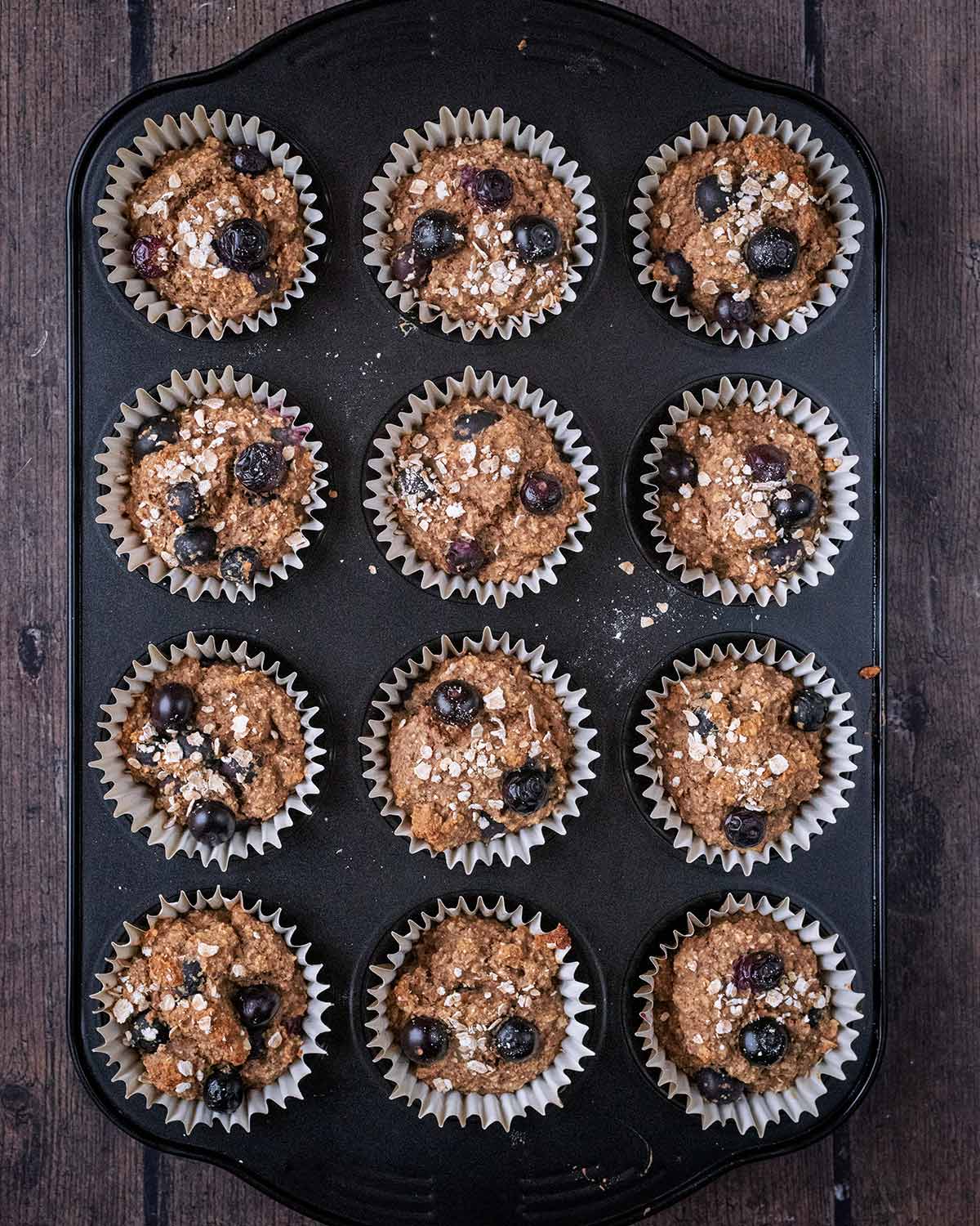 Twelve cooked muffins in a muffin tin.