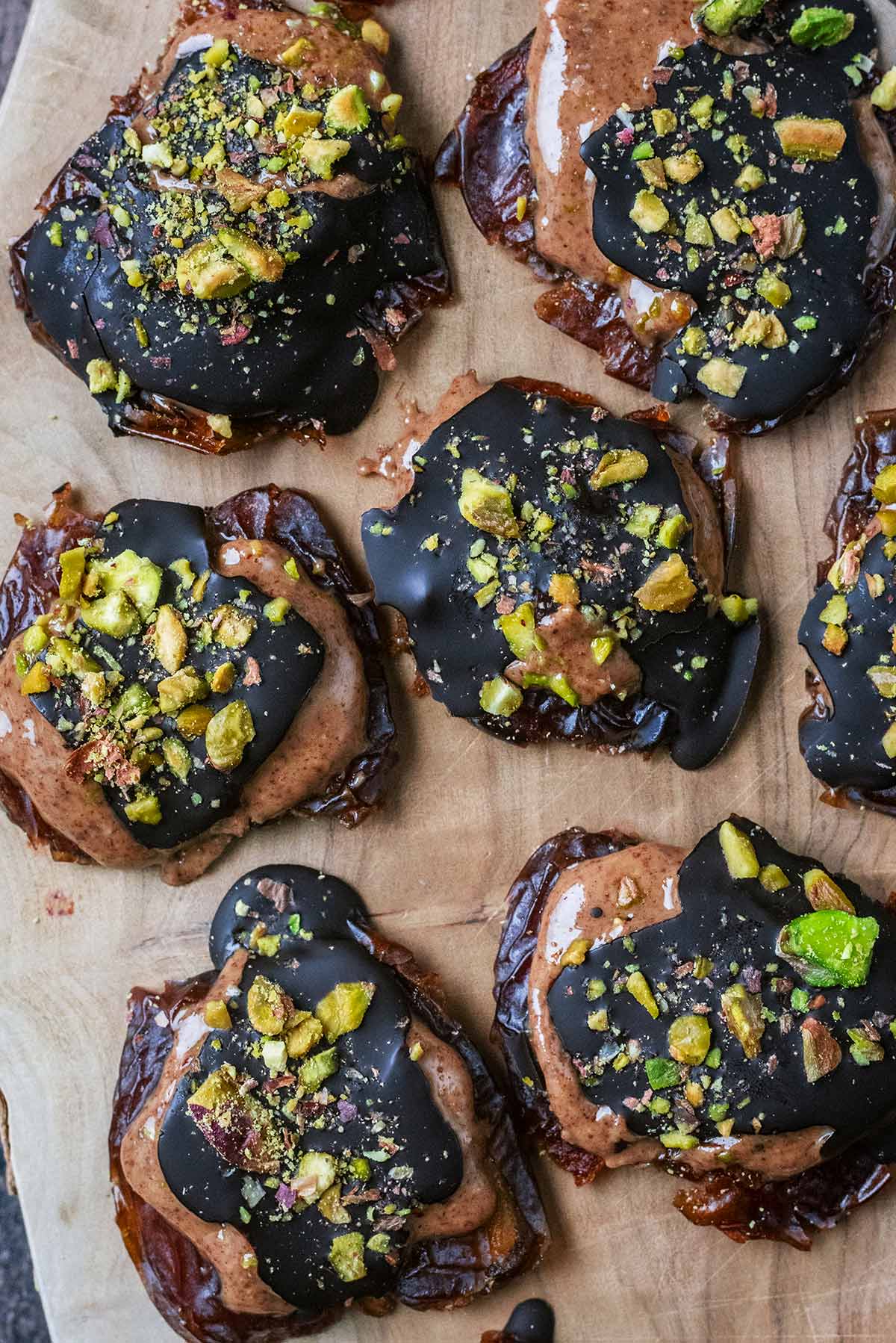 Crushed pistachios on top of chocolate covered date bark.