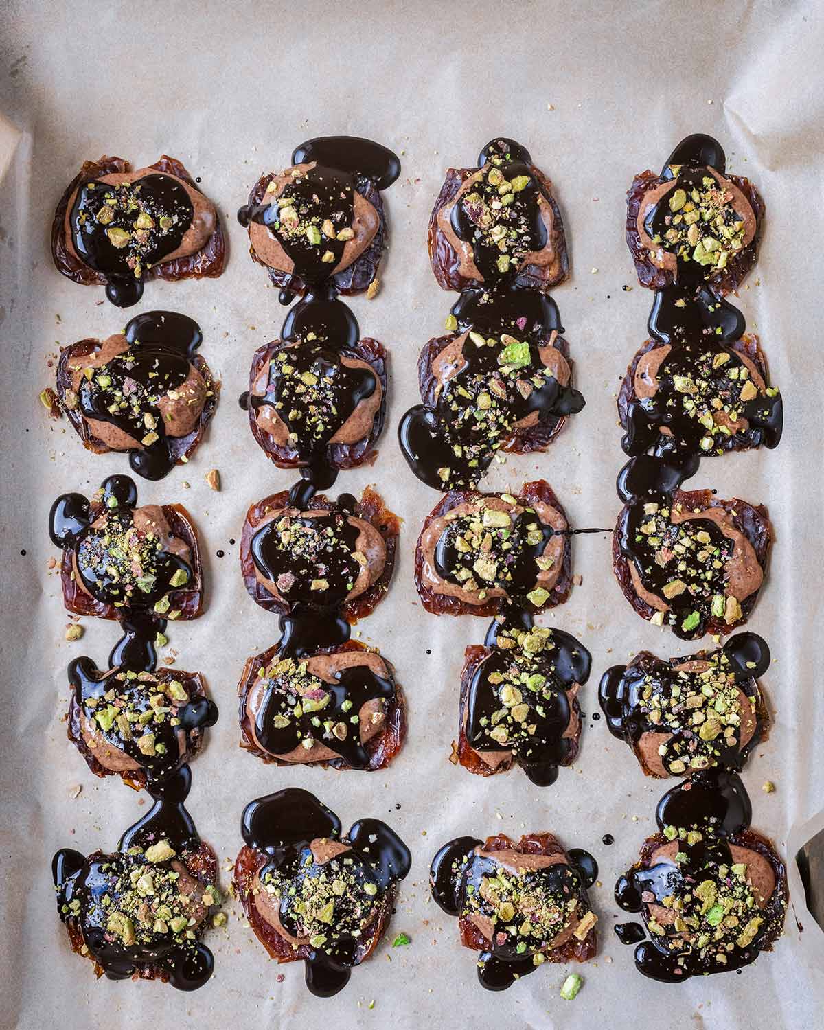 Melted chocolate spooned on top of the almond butter and then topped with crushed pistachios.